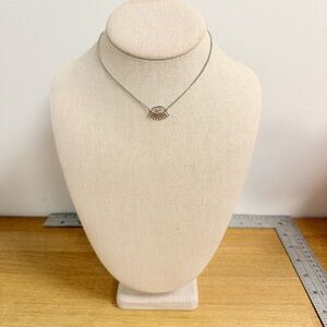 Gold tone upside down eye with eyelashes with crystal iris necklace